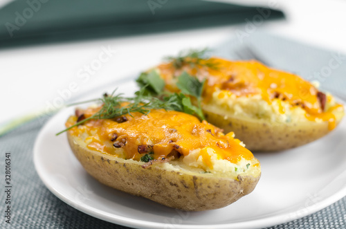 Cooked baked potato with pork belly and cheese.