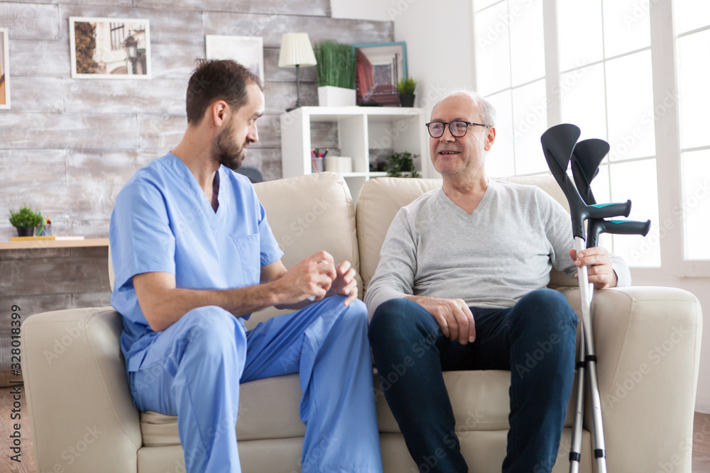 Elderly age man smiling while talking with male doctor Elderly age man smiling while talking with male doctor