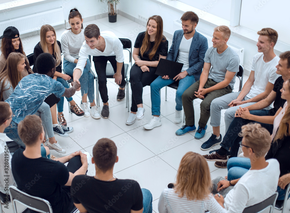 Fototapeta premium young people greet each other at a business training