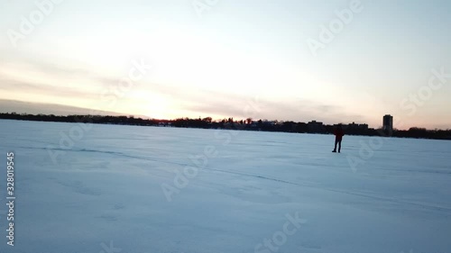 two person walking in snow during blue hour, frozen lake in Minnesota photo