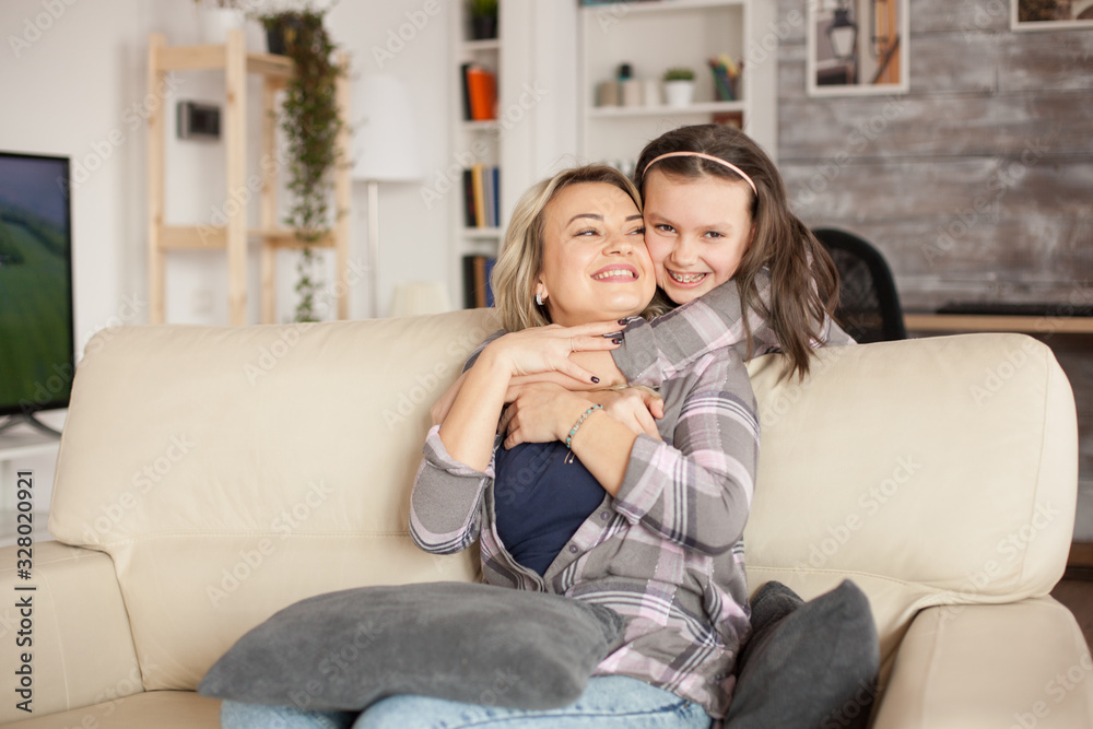 Little girl with braces showing her affection to her mother Little girl with braces showing her affection to her mother
