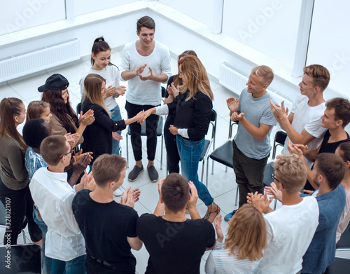 handshake of young like-minded people in a circle of friends