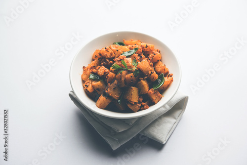 Kaccha Papita Sabji or Raw Papaya Sabzi, served in a karahi or bowl. selective focus photo