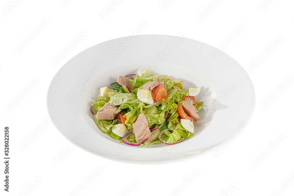 Caesar salad with tuna, tomato, onion, egg, olives, lettuce on plate, white isolated background, Side view. For the menu, restaurant bar cafe Caesar salad with tuna, tomato, onion, egg, olives, lettuce on plate, white isolated background, Side view. For the menu, restaurant bar cafe