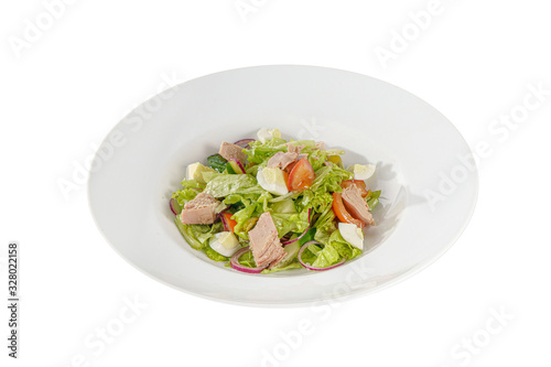 Caesar salad with tuna, tomato, onion, egg, olives, lettuce on plate, white isolated background, Side view. For the menu, restaurant bar cafe