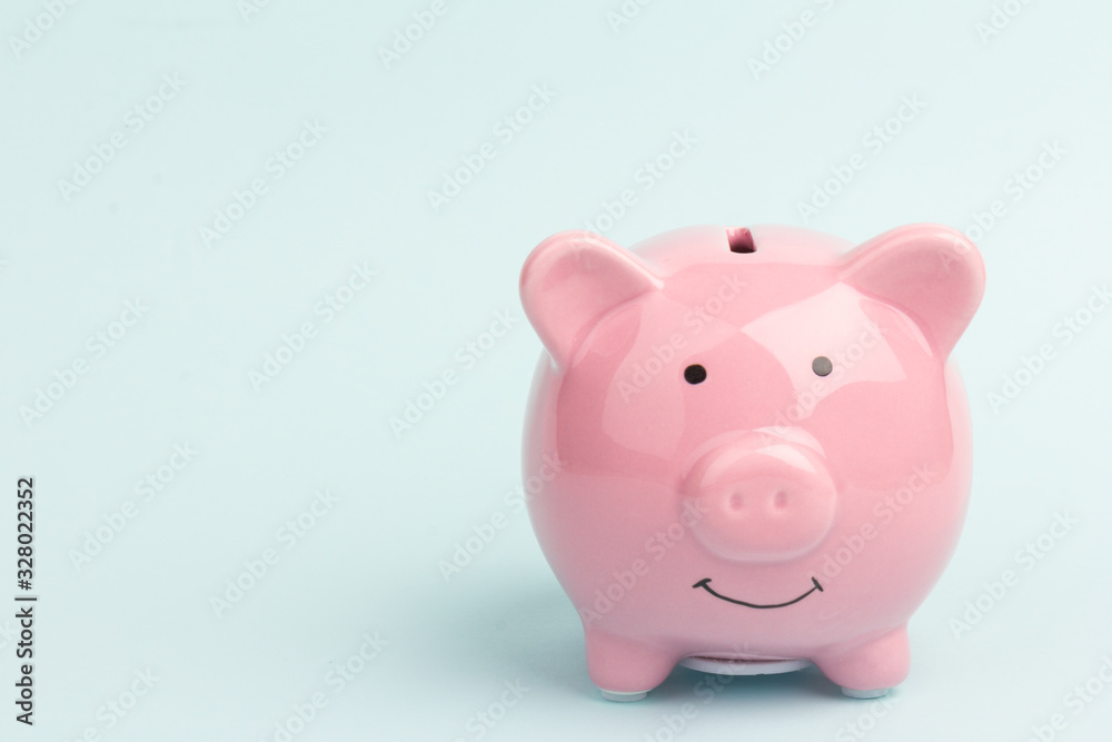 Piggy bank on blue background, space for text. Finance, saving money