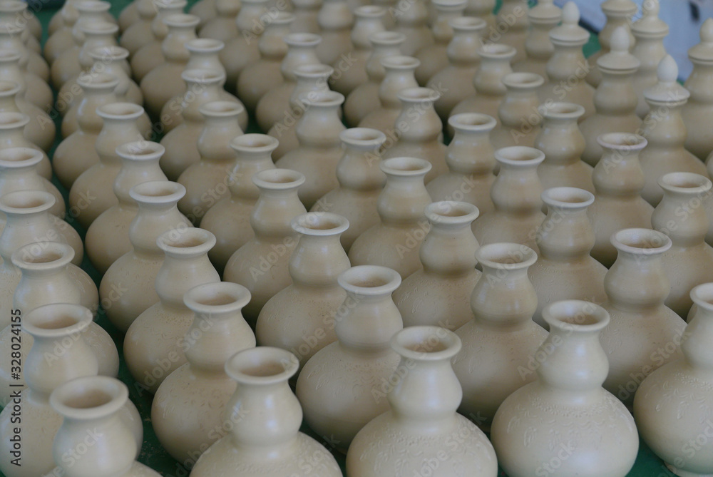 Selective focus of Handmade traditional Malay craft known as 'labu sayong'.It is a hand made water storage container. Clay pottery arts. Selective focus of Handmade traditional Malay craft known as 'labu sayong'.It is a hand made water storage container. Clay pottery arts.
