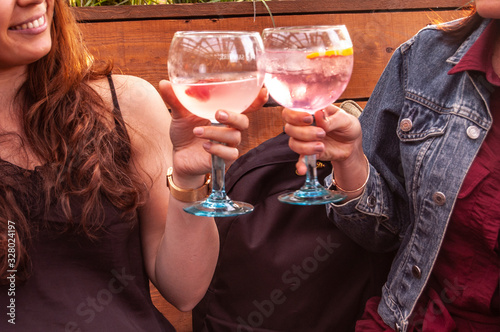 KENSINGTON, LONDON/ENGLAND – JULY 18 2019: Women drinking pink gin in summertime