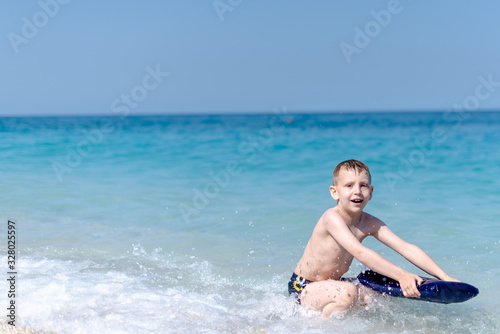 One boy is playing on the beach