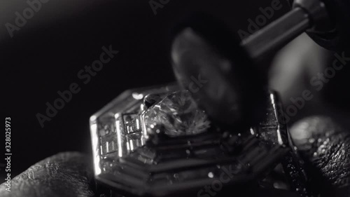 Man crafting a diamond ring jewel with his tools 
