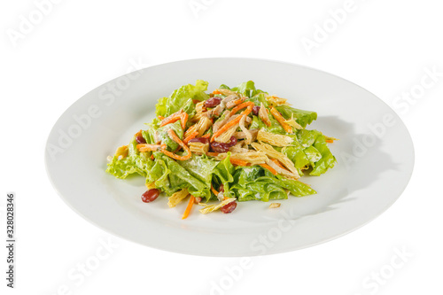salad with beans, asparagus, Korean carrots, chicken, lettuce on plate, white isolated background Side view. For the menu, restaurant, bar, cafe