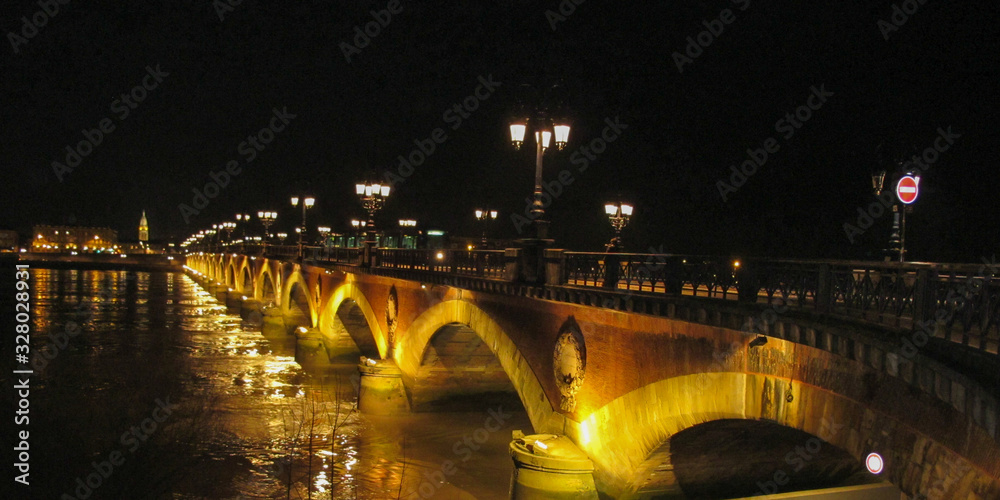Summer night bridge pont de pierre crossing Garonne river in Bordeaux city france