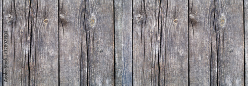 Natural wooden background. Vintage wooden texture. Old wooden boards with a knots close-up. Panoramic banner.