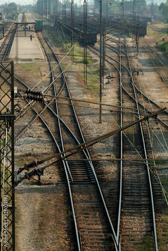 Railway tracks leading into a train station and freight yard
