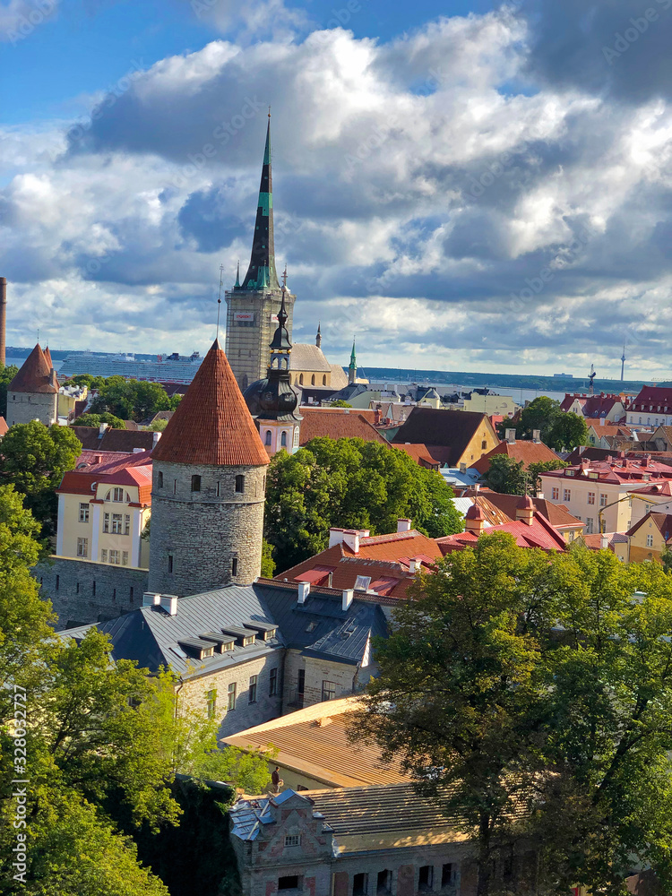 Tallinn,  Estonia : Old city of Tallinn seen from a lookout on Toompea hill. Traditional Red rooftops, Fort turret and  St Olaf's church top seen