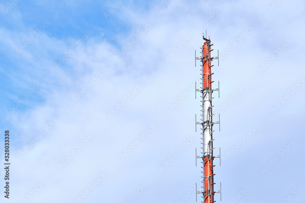 Close-up of the top of an antenna mast against bright sky with clouds and copy space. Seen near Kalchreuth in Franconia / Bavaria, Germany in February Close-up of the top of an antenna mast against bright sky with clouds and copy space. Seen near Kalchreuth in Franconia / Bavaria, Germany in February