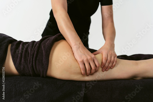Anti cellulite legs massage for young woman in beauty salon. Wellness center spa fat burning for perfect skin. Healthy lifestyle. White background isolated