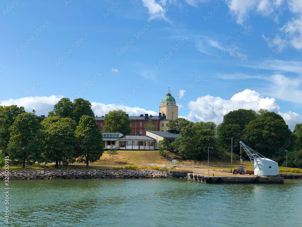 Suomenlinna, Sveaborg sea fortress and top of Kirkko church seen from boat cruise. Helsinki, Finland
