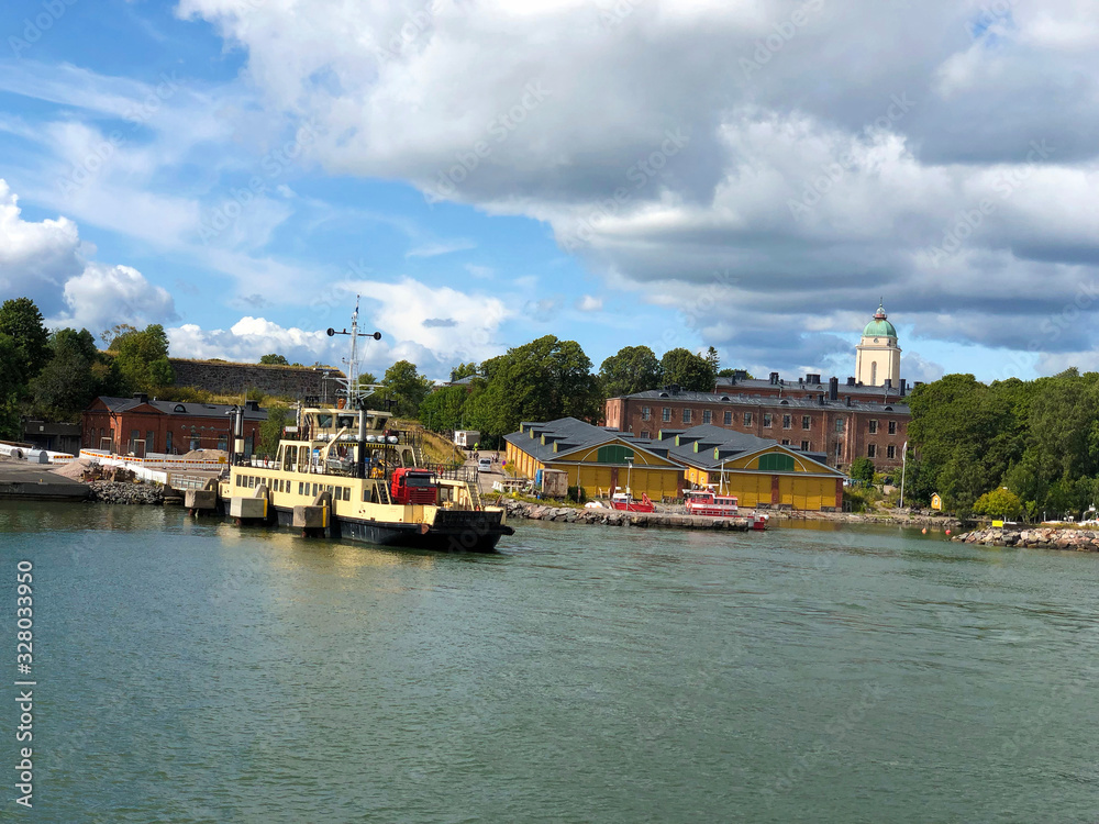 Helsinki, Finland :  Suomenlinna, Sveaborg sea fortress and top of Kirkko church seen from boat cruise
