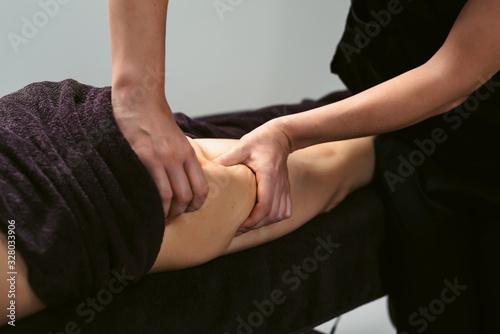 Anti cellulite legs massage for young woman in beauty salon. Wellness center spa fat burning for perfect skin. Healthy lifestyle. White background isolated