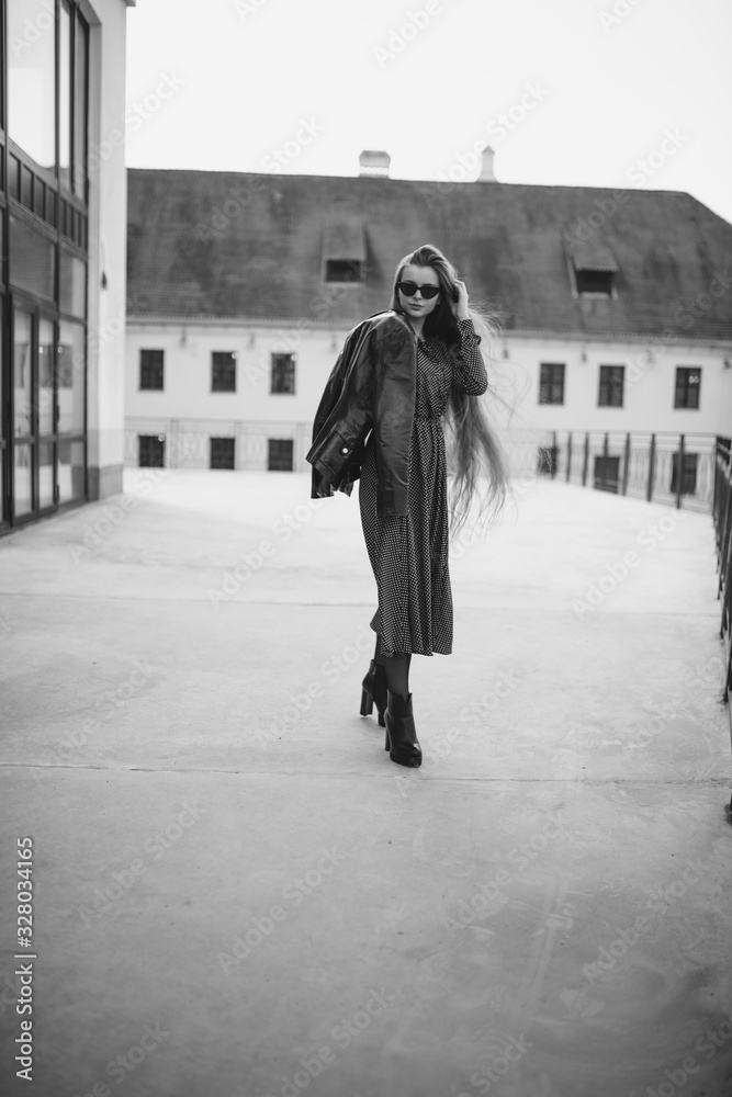 a girl with glasses and a hat is walking around the city a girl with glasses and a hat is walking around the city