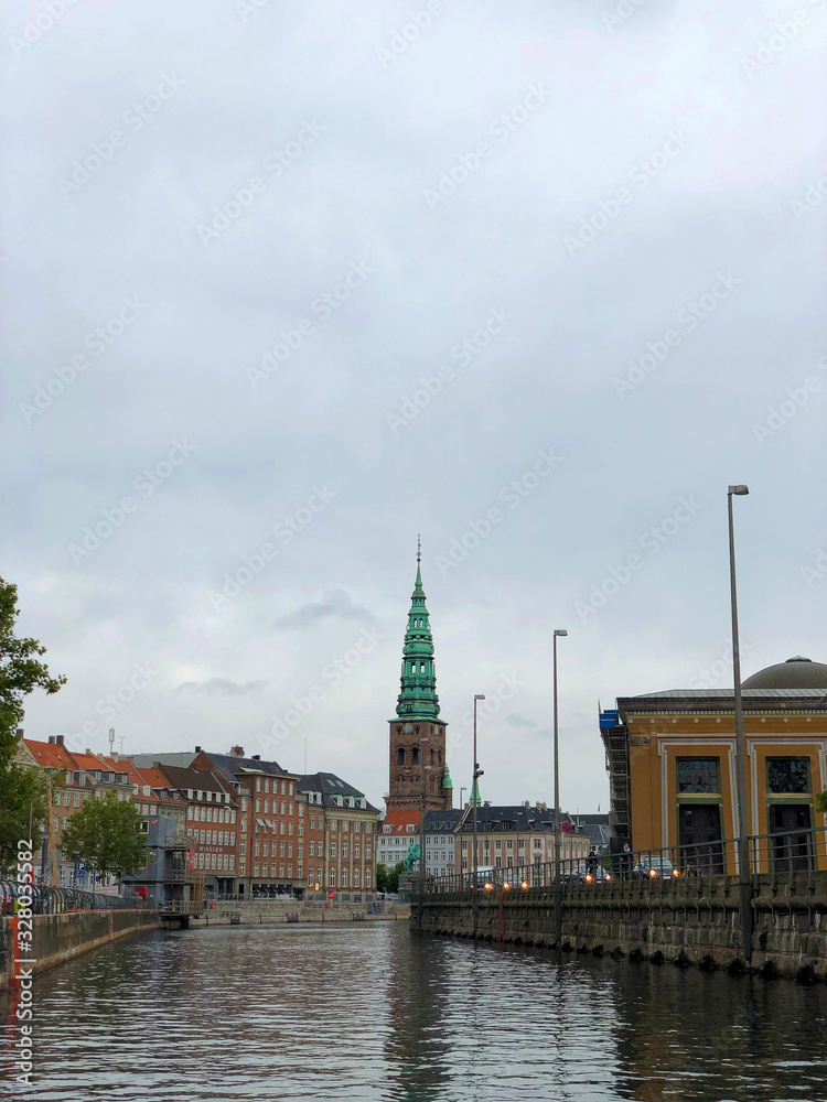 Tourist boat on Gammel Strand canal. Nikolaj Kirke Church and Thorvaldsens museum on the background at Copenhagen, Denmark