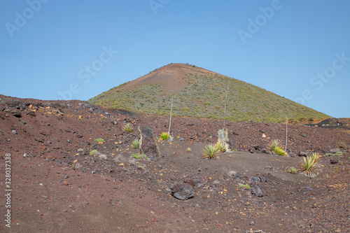 Walk in the arid volcanic landscape with scarce vegetation connecting Santiago del Teide to Arguayo, a popular difficult trail in search of the flowering almond trees, Tenerife, Canary Islands, Spain photo