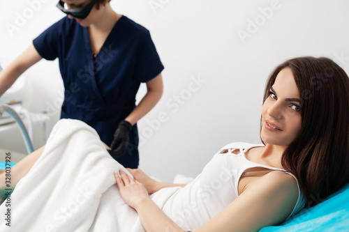 Woman getting laser treatment in a beauty salon.
