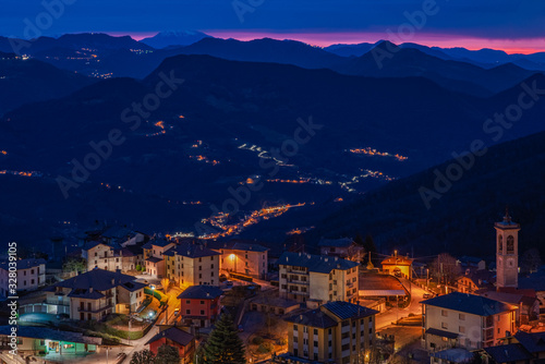 The sun rises over a small mountain village