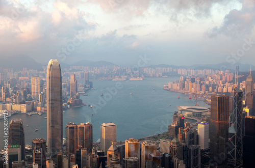 Cityscape Hong Kong on wide harbor banks against hills © Yan