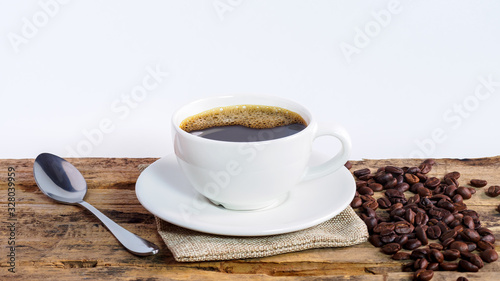 Coffee cups and coffee beans roasted on a wooden table