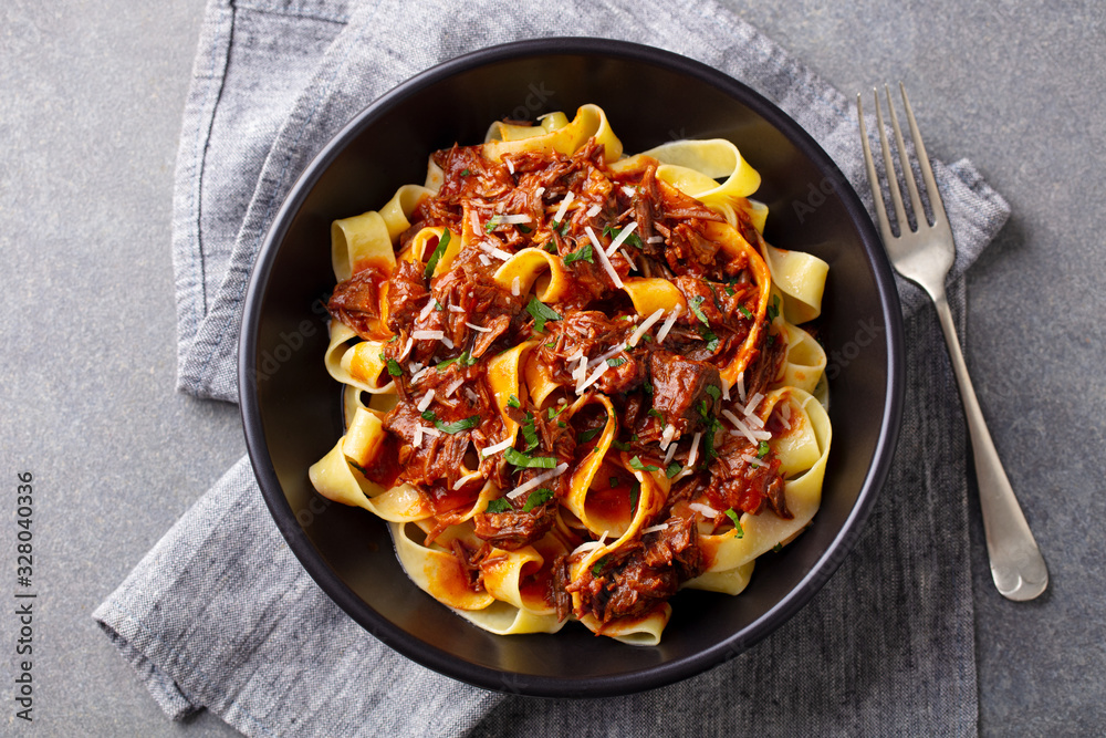 Ταπετσαρία Pasta pappardelle with beef ragout sauce in black bowl