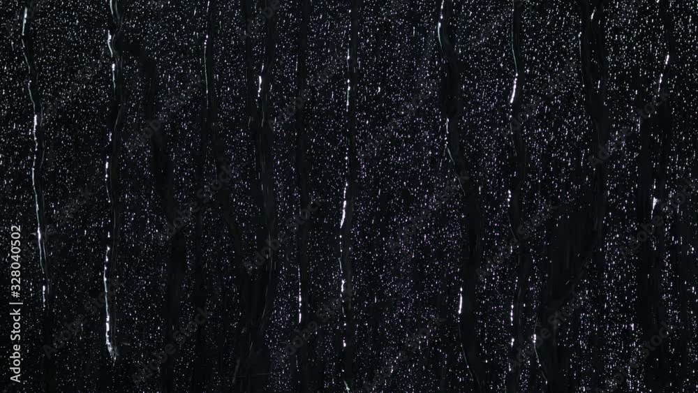 A lot of raindrops of white water falling down. Perfect for digital composing. Pure black background.