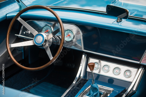 Wooden steering wheel and dashboard of an old classic car