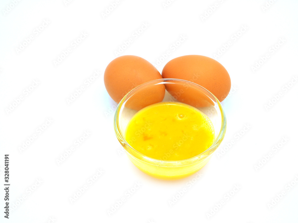Mix the eggs in a glass bowl, to prepare as an ingredient for cooking or baking in the kitchen isolated on white background. Mix the eggs in a glass bowl, to prepare as an ingredient for cooking or baking in the kitchen isolated on white background.