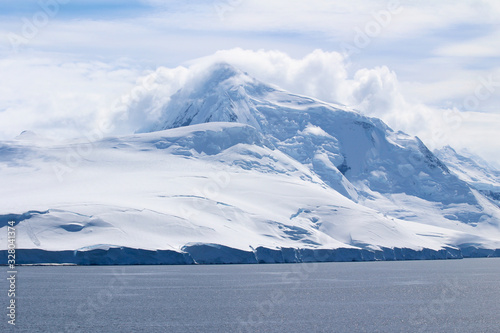 Landscape of snowy mountains and frozen coasts along the Danco Coast in the Antarctic Peninsula, Antarctica