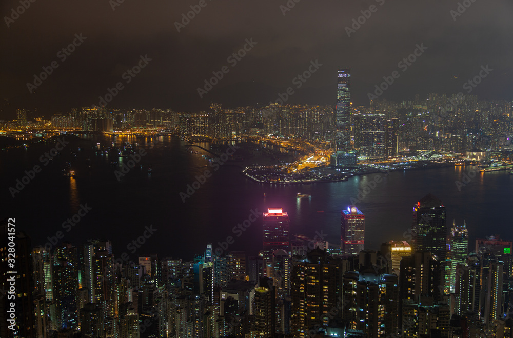 Fototapeta premium Cityscape famous Hong Kong buildings towers by night harbor