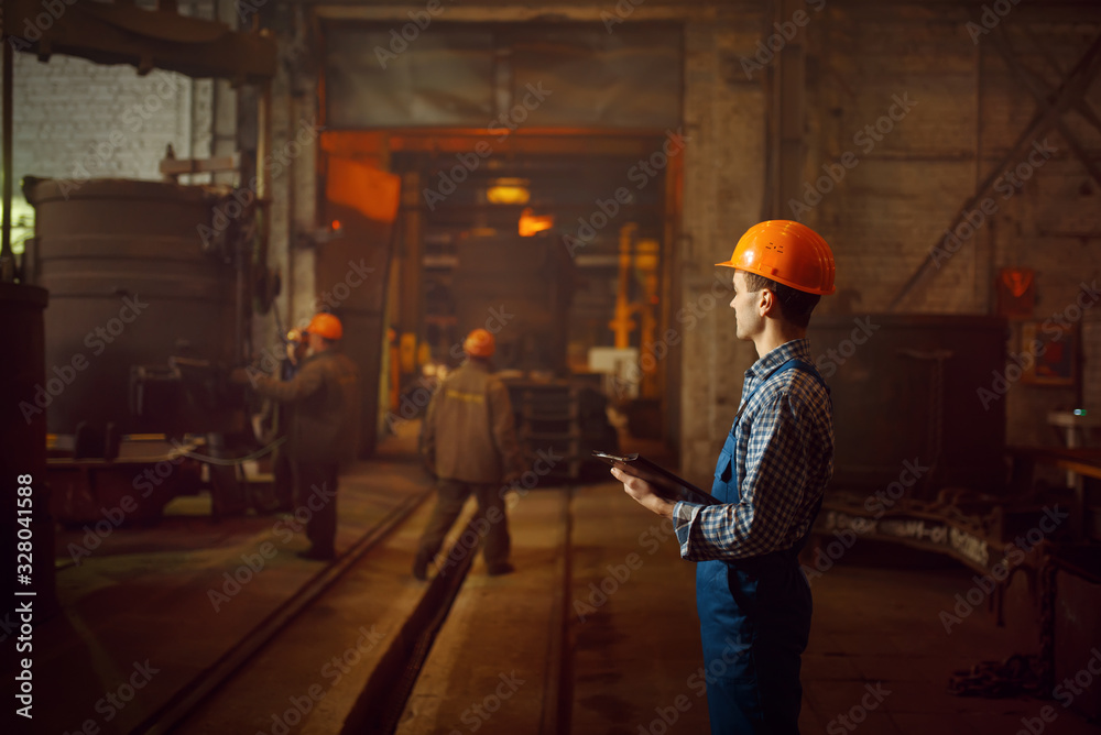 Master looks on steelmaking process in furnace Master looks on steelmaking process in furnace
