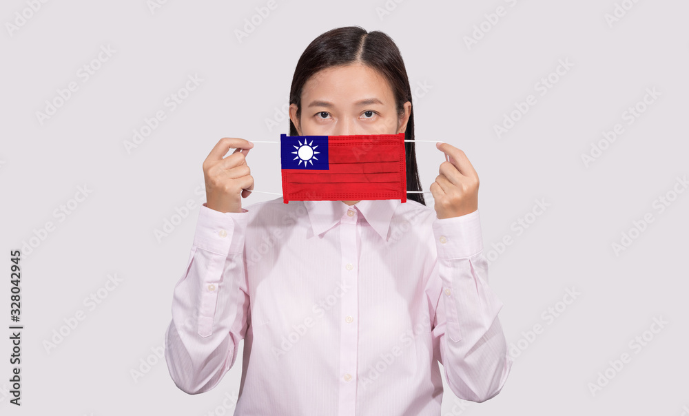Asian woman wearing hygienic face mask painting Taiwan flag to protect from the Coronavirus 2019 (COVID-19) infection outbreak situation, the virus originated from Wuhan, China. Asian woman wearing hygienic face mask painting Taiwan flag to protect from the Coronavirus 2019 (COVID-19) infection outbreak situation, the virus originated from Wuhan, China.