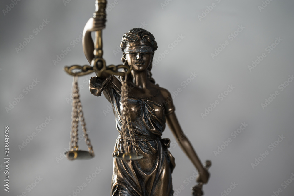 Themis. Law and Jusitce concept photo, grey stone background Themis. Law and Jusitce concept photo, grey stone background
