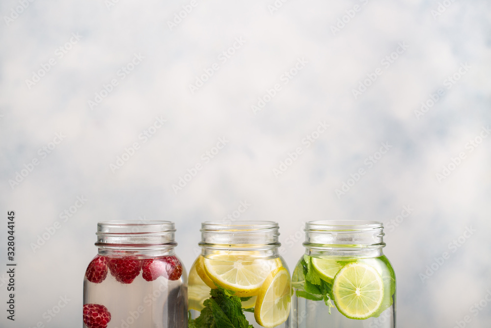 Detox water in jars with raspberries, lemon, lime and mint. Detox water in jars with raspberries, lemon, lime and mint.