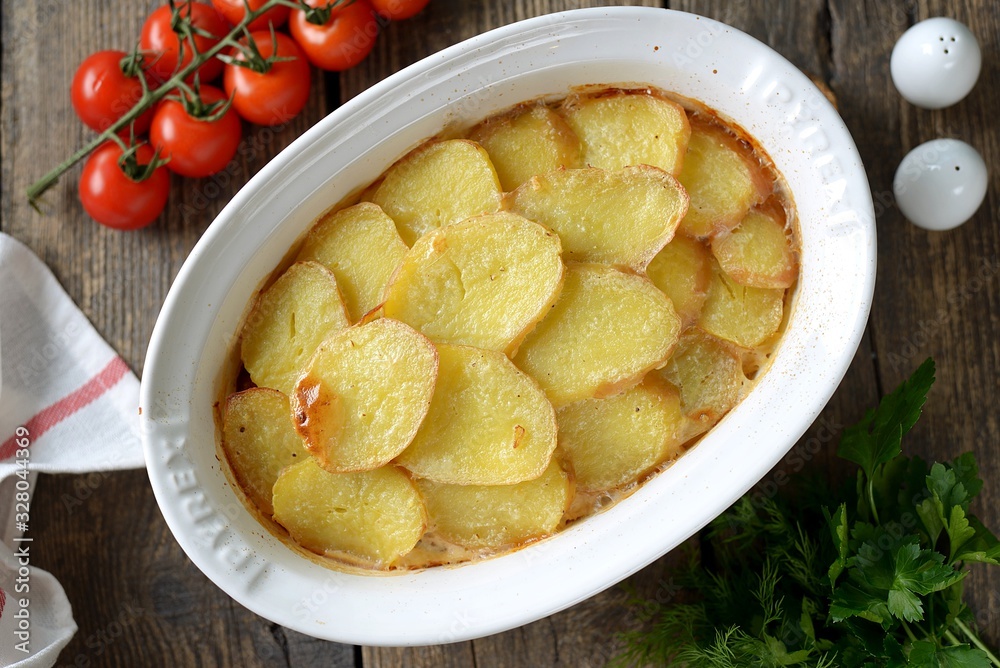 Potato casserole with onions sour cream on an old wooden background. Rustic style. Potato casserole with onions sour cream on an old wooden background. Rustic style.