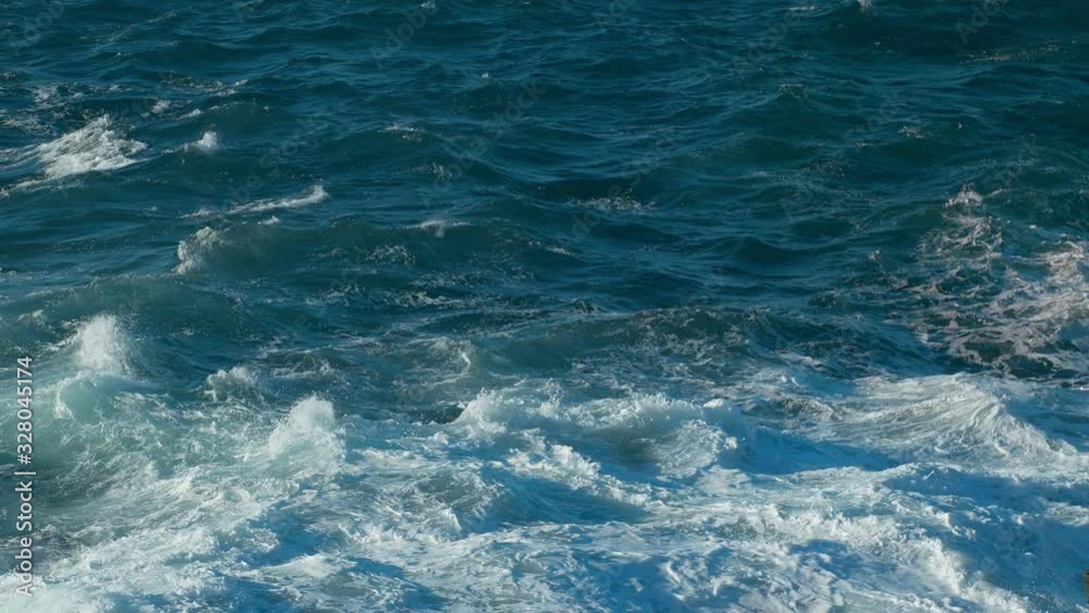 Waves of Ocean Water crash on the rocks of the Volcanic island of Tenerife Beginning of Life in Sea Tide turns into pearl drops and splashes Waves reflect the sun's rays shot 4.6K