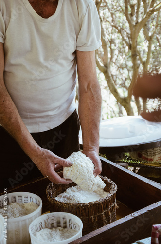Man making cottage cheese outdoor