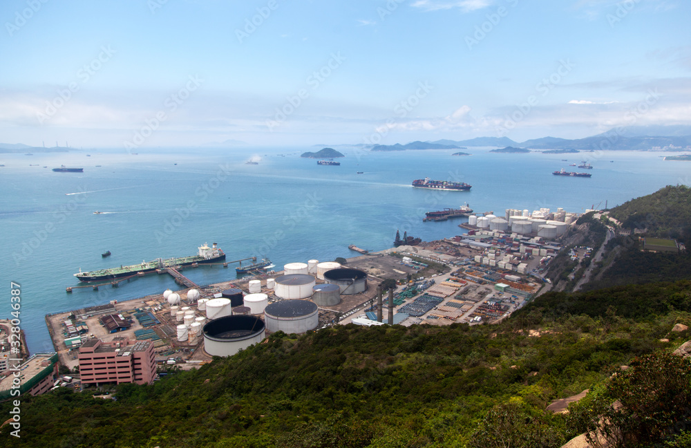 Container port huge cranes load large cargo vessel in Hong Kong