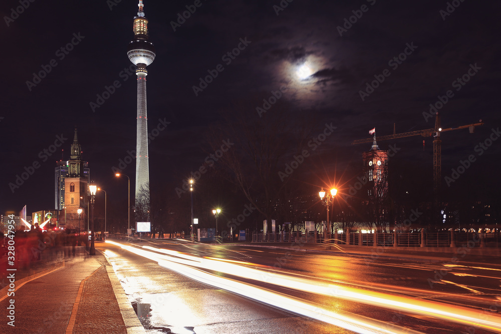 Street view of St. Mary Church (Marienkirche) and TV Tower (Fernsehturm) at night in Berlin, Germany.
