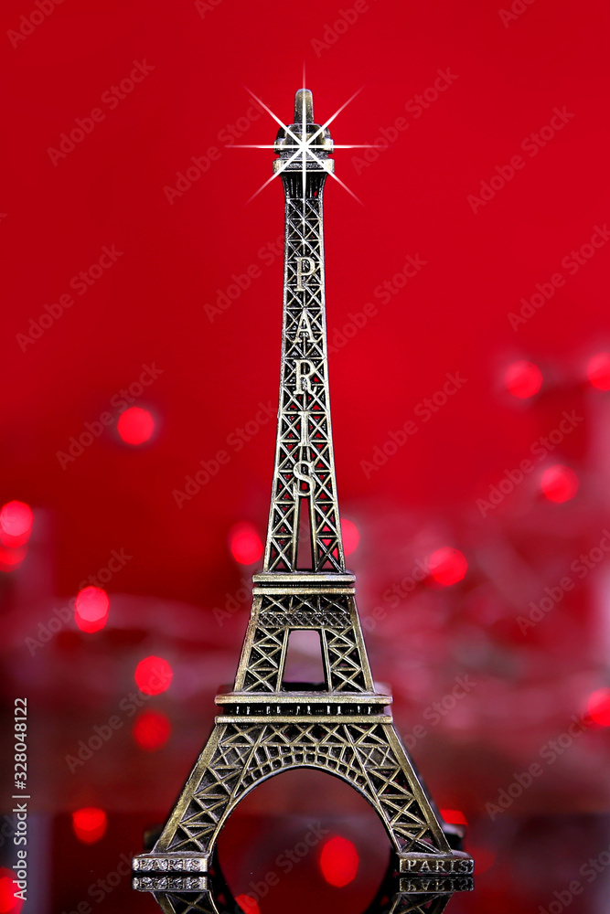 eiffel tower souvenir with red background and lights