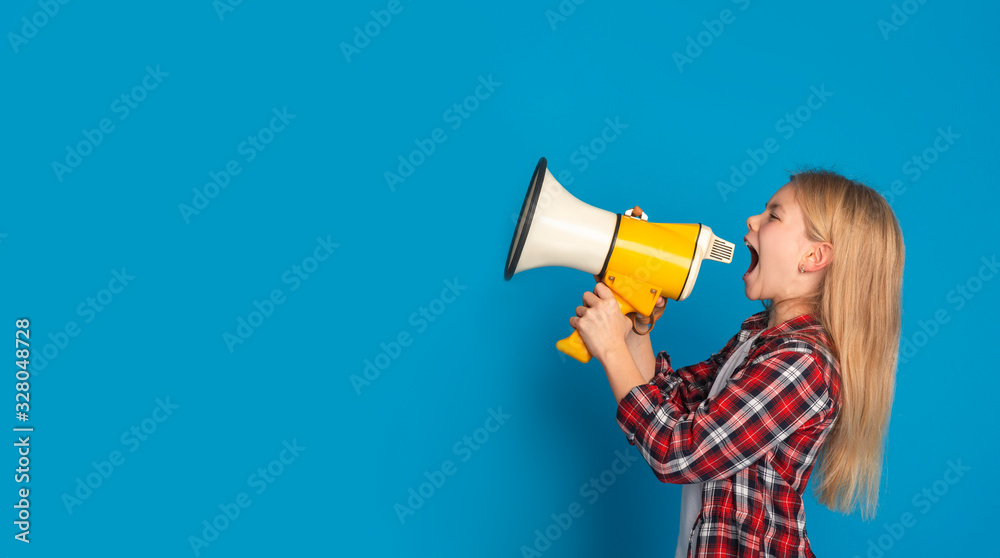 Emotional little girl shouting at copy space with megaphone, making announcement Emotional little girl shouting at copy space with megaphone, making announcement