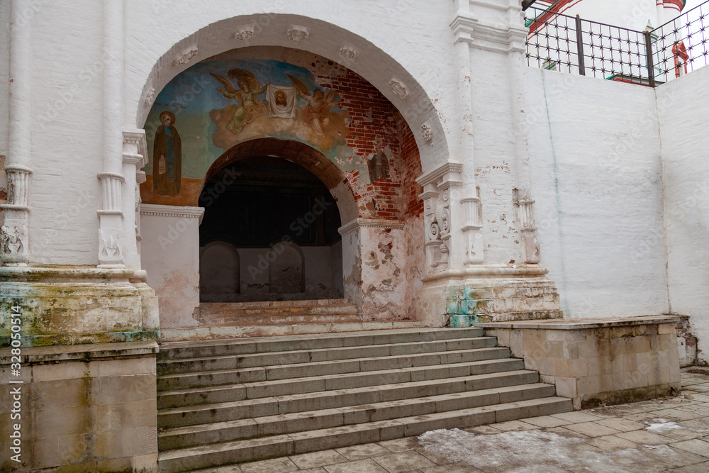 The picturesque main gate of the Orthodox monastery, decorated with frescoes depicting saints