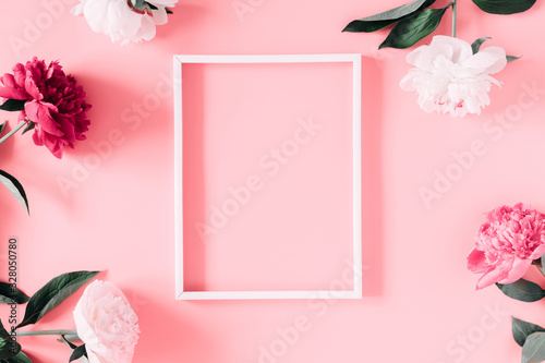 Fototapeta Naklejka Na Ścianę i Meble -  Beautiful flowers composition of peonies. Photo frame, pink and white peonies flowers on pastel pink background. Flat lay, top view, copy space